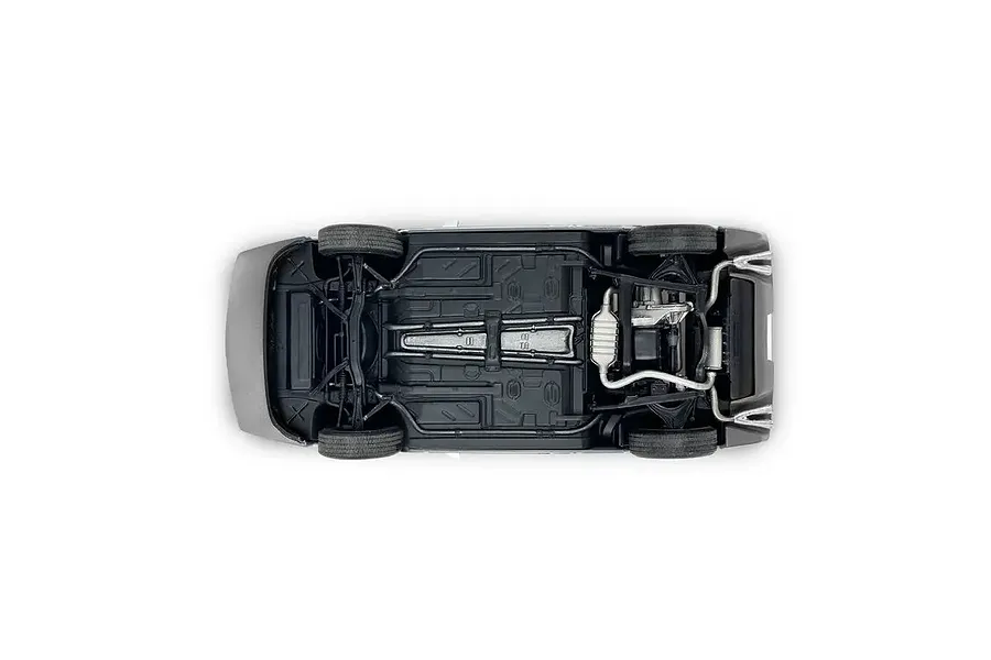 Bottom view of a 1/24 scale model car chassis showing suspension, exhaust, and drivetrain details.