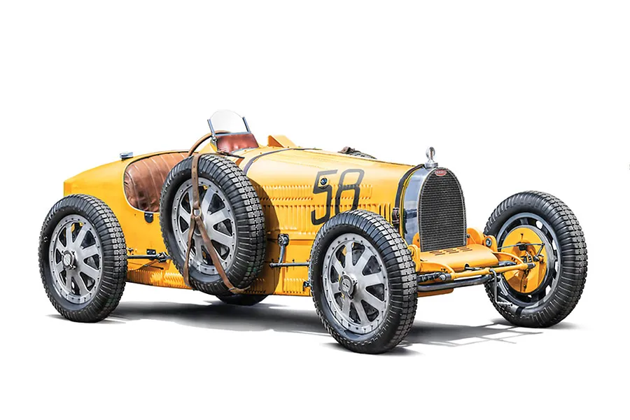 A yellow vintage Bugatti Type 35B race car model with number 58 on the side, displayed against a white background.