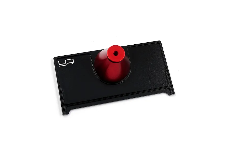 Yeah Racing 1/28 scale tyre mounter tool featuring a black rectangular base and a red conical mounting post.