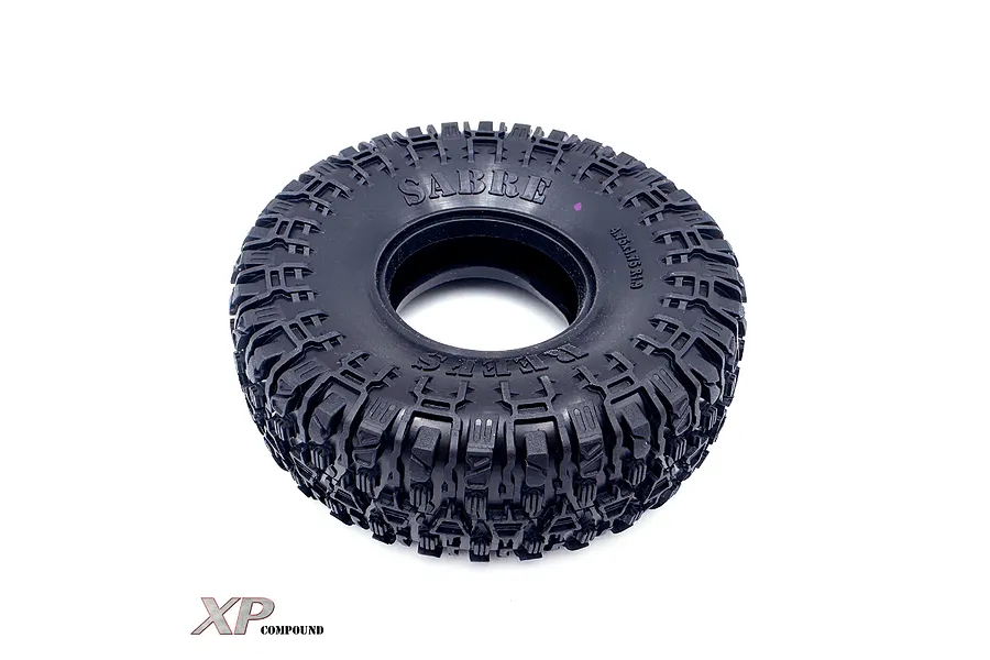 A single Reefs RC 1.9 inch Sabre XP compound black rubber RC crawler tyre viewed from an angle against a white background.