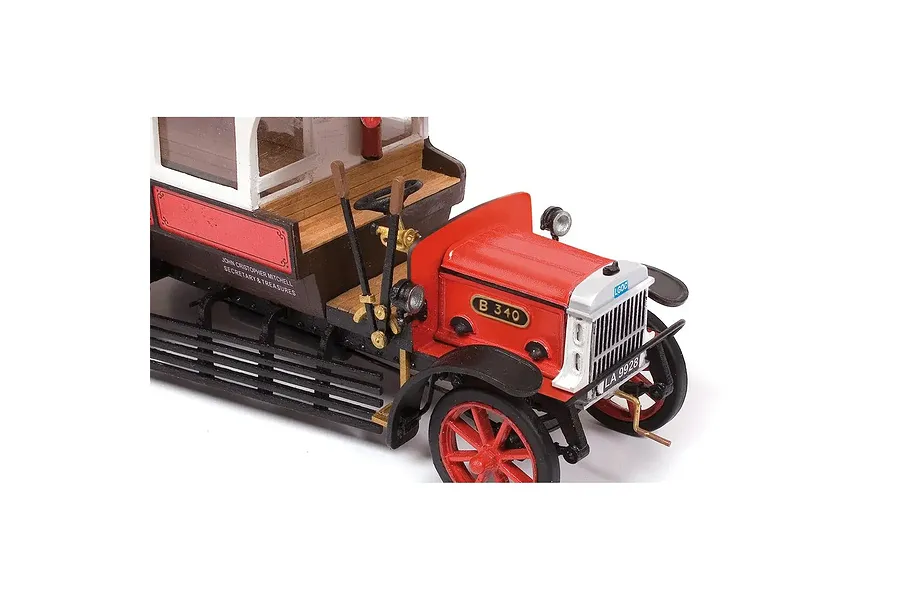 A close-up view of the front section of a detailed 1/24 scale wooden model of an AEC B-Type bus, featuring red and black paintwork and vintage detailing.