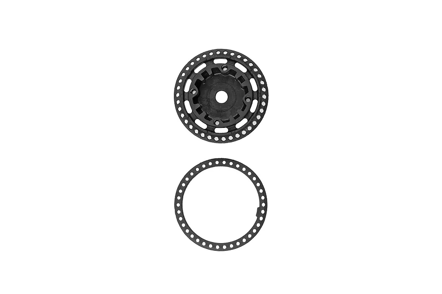 A black plastic differential case and a matching circular gasket for a Team Associated RC car.