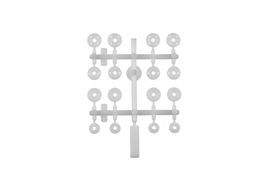 A white plastic parts tree containing various circular shock pistons and bushings for RC car suspension.
