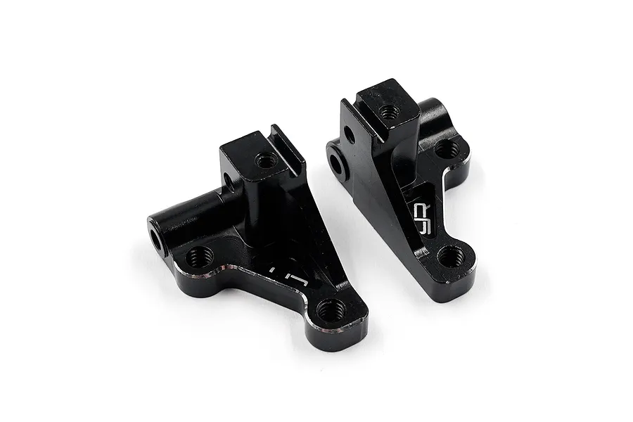 Two black anodized aluminium RC front lower arm mounts by Yeah Racing, shown from an elevated angle on a white background.