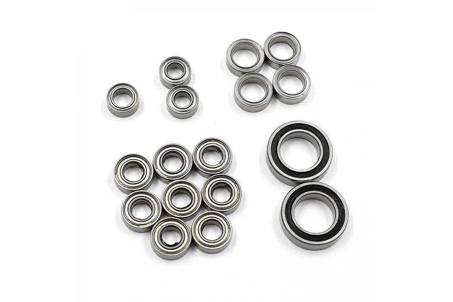 A collection of 17 metal ball bearings of various sizes arranged on a white background for the RC10T bearing kit.