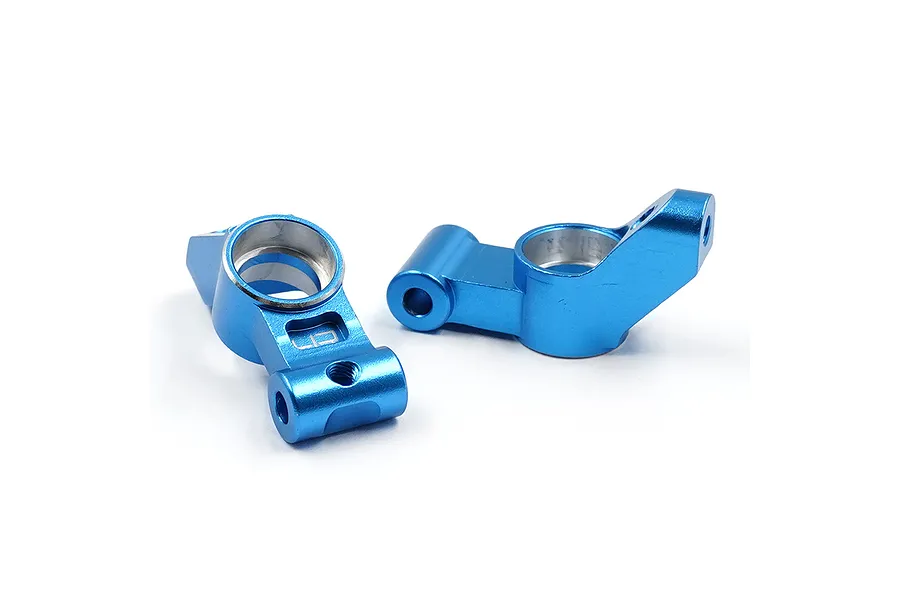 Two blue anodized aluminium rear hub carriers for an RC car, shown from different angles on a white background.