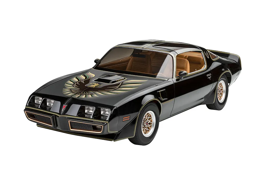 A completed 1/8 scale model of a black Pontiac Firebird Trans Am with gold decals and tan interior, shown against a white background.