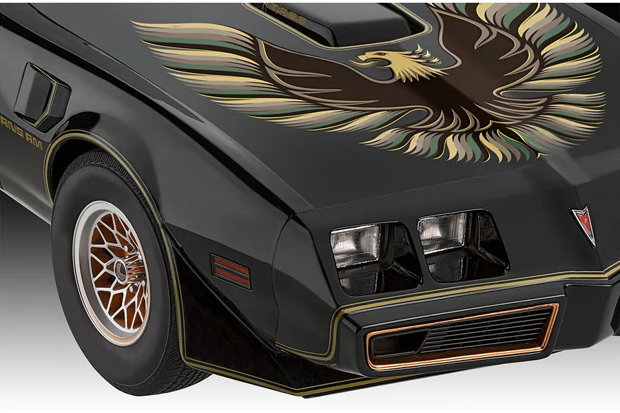 Close-up of a black Revell 1/8 scale Pontiac Firebird Trans Am model car featuring the iconic hood eagle decal and gold pinstriping.