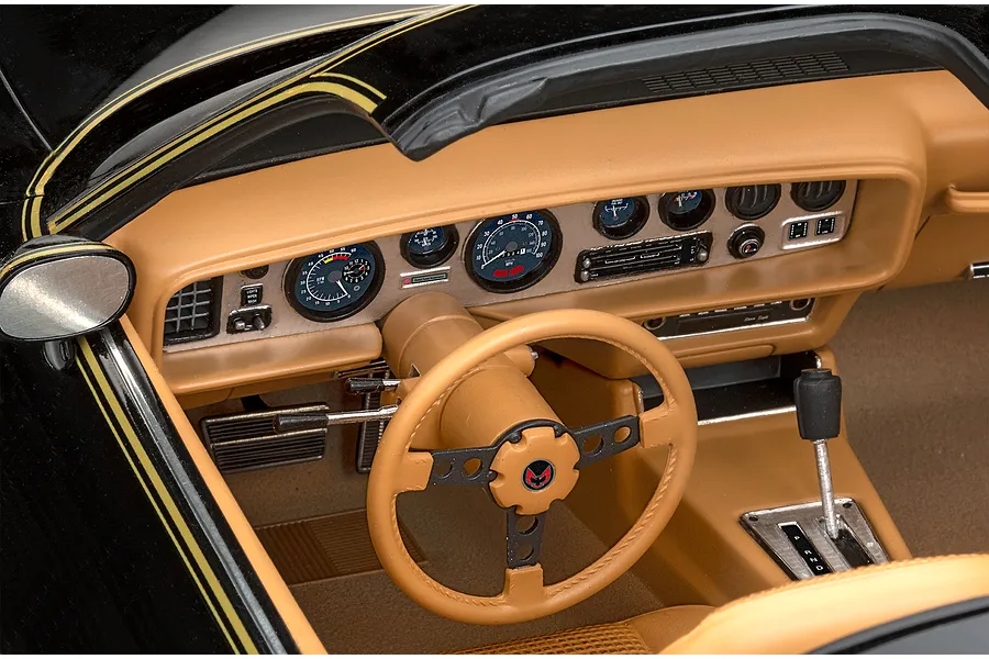 Close-up of the detailed tan interior and dashboard of a 1/8 scale Pontiac Firebird Trans Am model car.