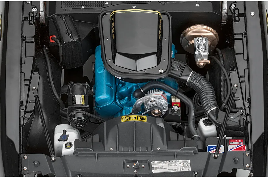 Top-down view of the detailed engine bay of a Revell 1/8 scale Pontiac Firebird Trans Am model kit, featuring a blue engine block and black air cleaner.