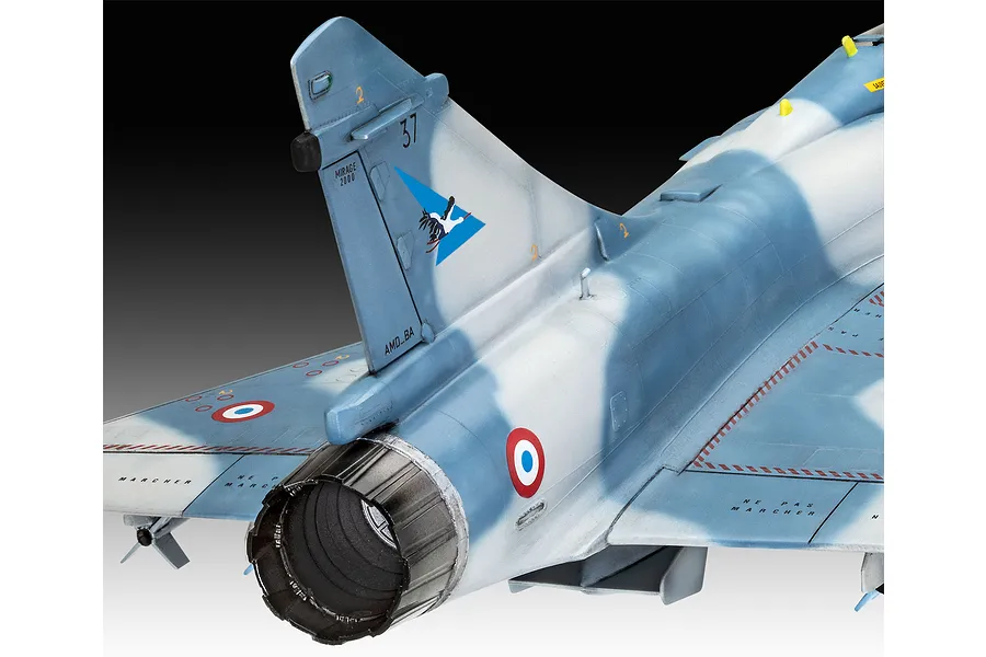 Close-up of the rear section of a painted 1/48 scale Dassault Mirage 2000C plastic model aircraft, showing the tail fin, engine nozzle, and camouflage.