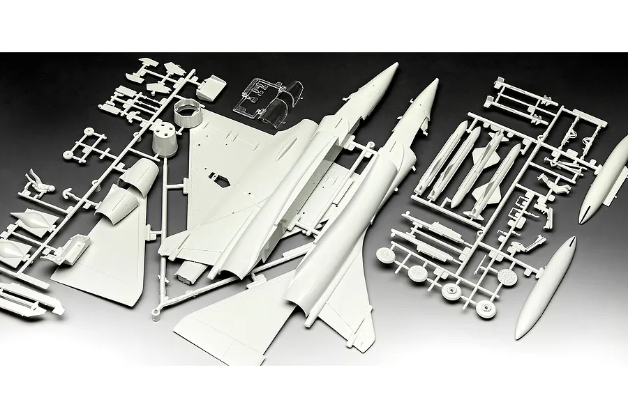 Unassembled plastic model kit parts for a Dassault Mirage 2000C fighter jet, including fuselage, wings, and weapons on grey sprues.