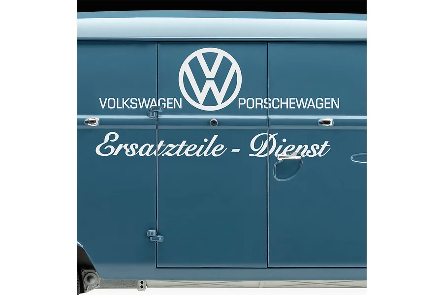 Close-up of the side panel of a blue Revell VW T1 model van featuring white Volkswagen PORSCHEWAGEN Ersatzteile-Dienst decals and chrome door handles.
