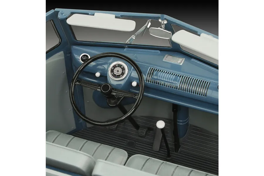 Close-up interior view of a 1/16 scale Revell VW T1 model van showing the dashboard, steering wheel, and front seats.
