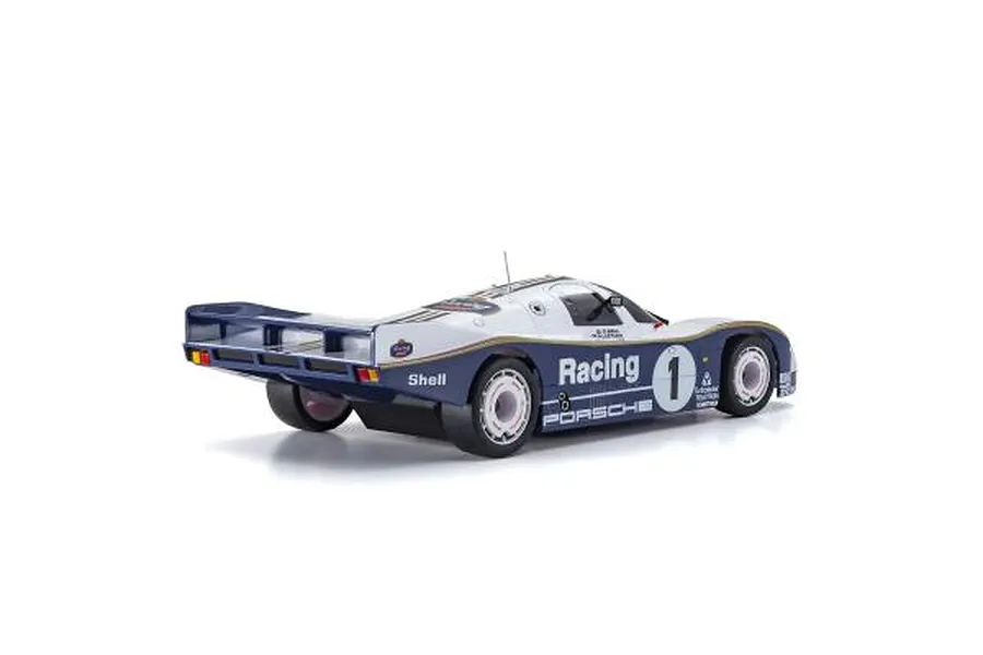 Rear three-quarter view of a Kyosho Mini-Z Porsche 962 C race car body shell in white and blue livery with number 1.
