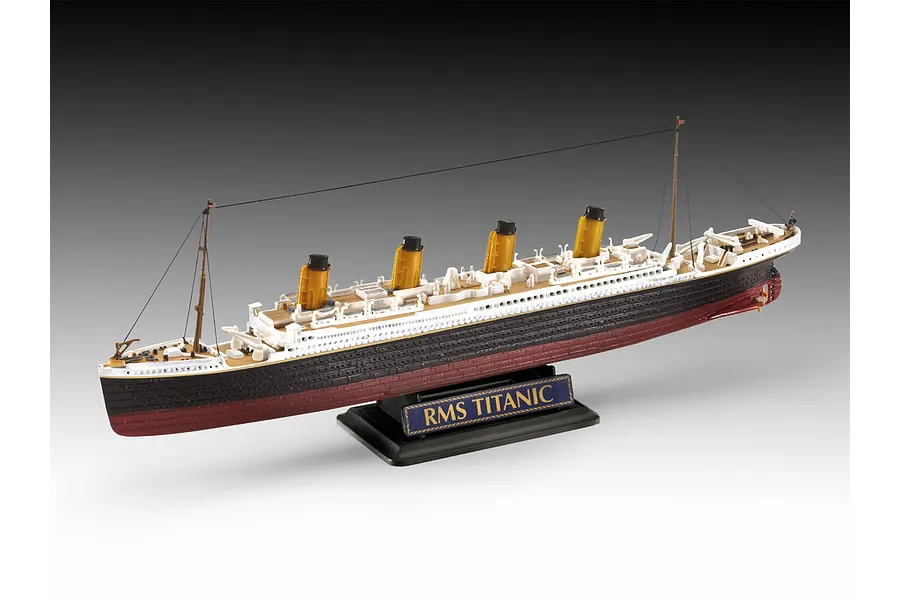 A finished plastic model of the RMS Titanic on a black display stand against a gradient grey background.