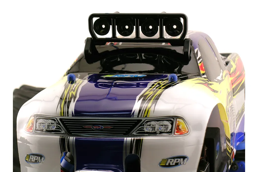 A close-up view of an RC truck body featuring an RPM four-bucket light bar mounted on the roof.