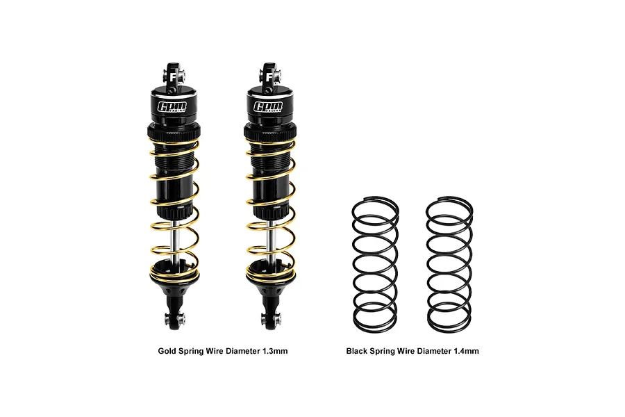 Two GPM Racing black aluminium RC shock absorbers with gold springs, plus two additional black springs, isolated on a white background.
