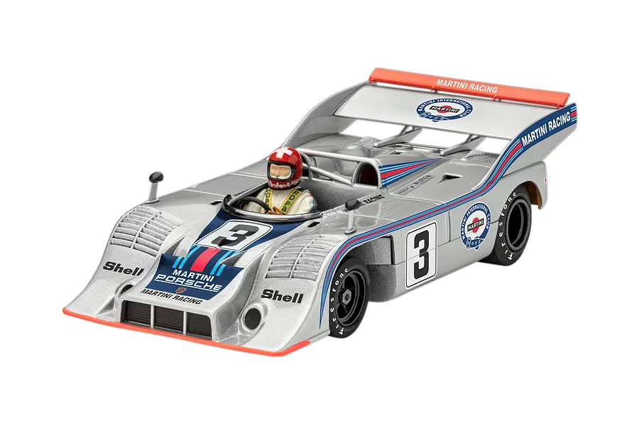 A high-angle studio shot of a 1/32 scale Revell Porsche 917 CanAm model car in silver Martini Racing livery with driver figure.