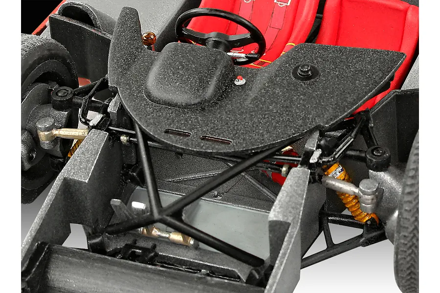 Close-up view of the interior cockpit and front suspension assembly of a 1/32 scale Porsche 917 model car kit.
