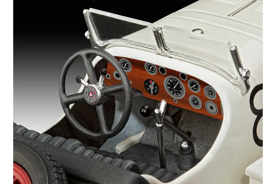 Close-up of the detailed cockpit interior of a 1/32 scale Revell Mercedes-Benz SSKL model car, showing the dashboard, steering wheel, and gear shifter.
