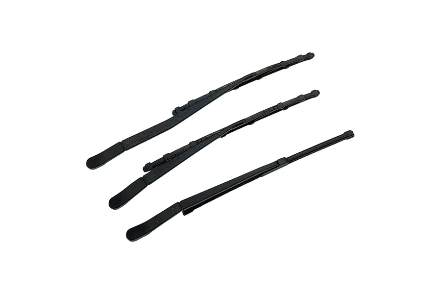 Three black plastic RC car windscreen wiper accessories arranged diagonally against a white background.