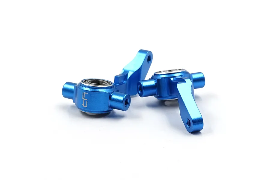 Two blue anodized aluminium RC steering hubs from Yeah Racing, featuring integrated ball bearings and laser-etched branding.
