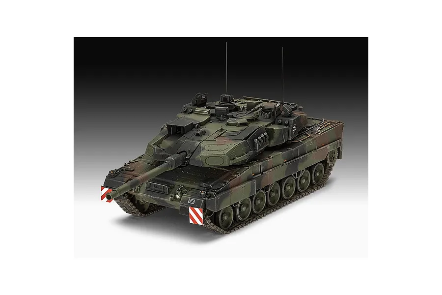 A studio shot of a fully assembled and painted 1/35 scale Revell Leopard 2A7A1 battle tank model with camouflage paint and red and white warning markers.