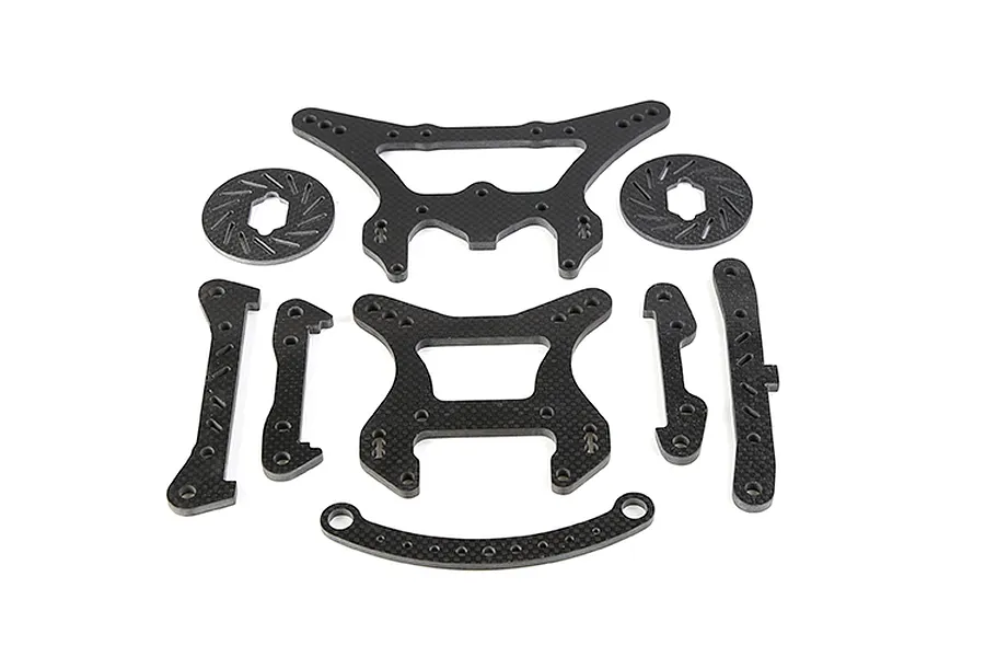 A set of Rovan carbon fibre RC car parts including shock towers, braces, and brake discs arranged on a white background.