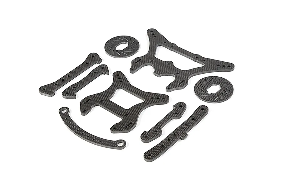 A set of Rovan carbon fibre RC car parts including shock towers, braces, and two brake discs arranged on a white background.