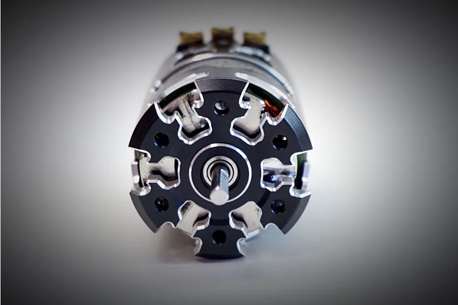 Front view of a Team Powers Actinium V5 sensored brushless motor showing the black and silver machined end bell and central output shaft.