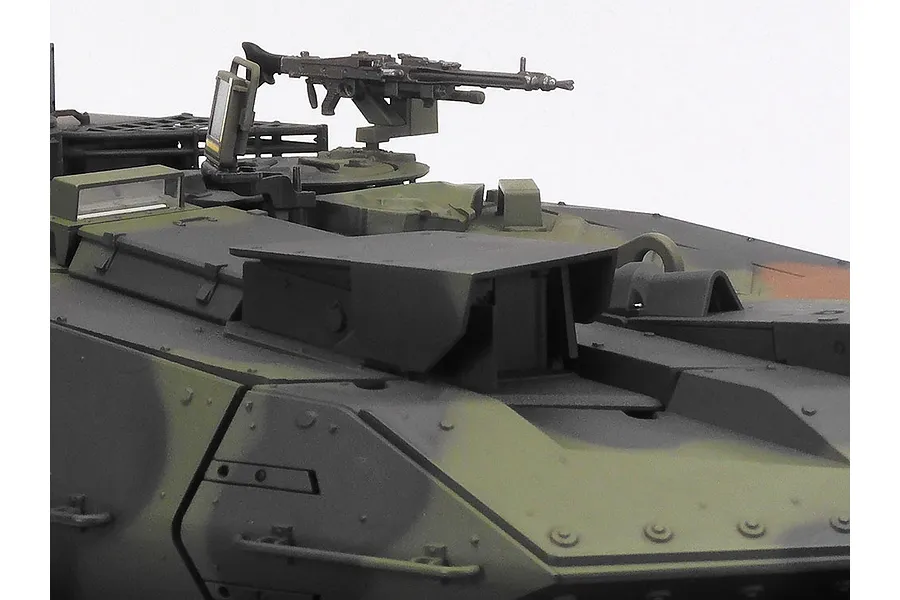 Close-up of the turret area of a Tamiya Leopard 2 A7V RC tank model, showing the machine gun mount and camouflage paint scheme.