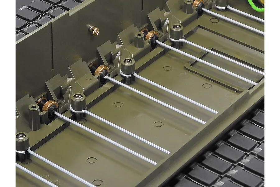 Close-up of the internal torsion bar suspension system on a Tamiya 1/16 scale Leopard 2 A7V RC tank chassis.