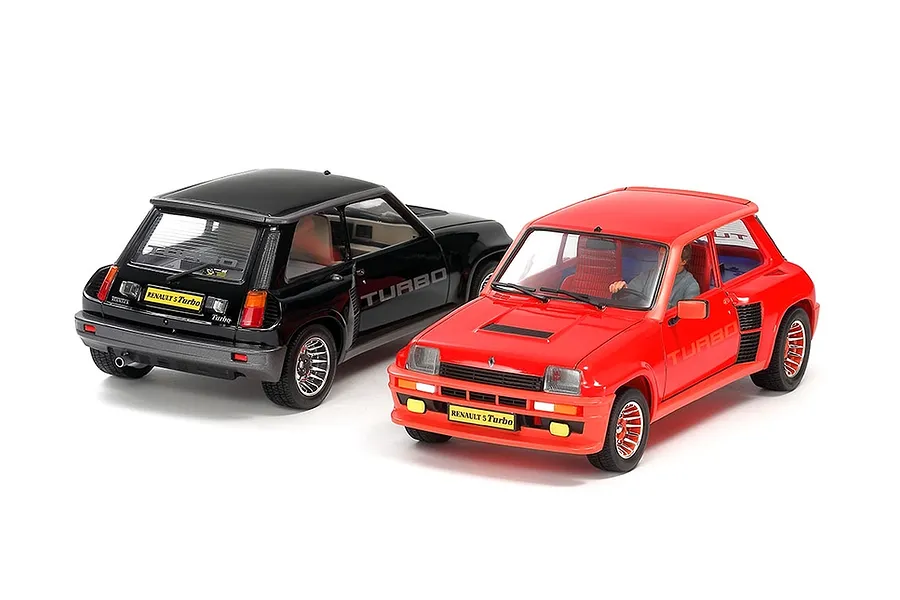 Two 1/24 scale Tamiya Renault 5 Turbo model cars, one black and one red, displayed on a white background.