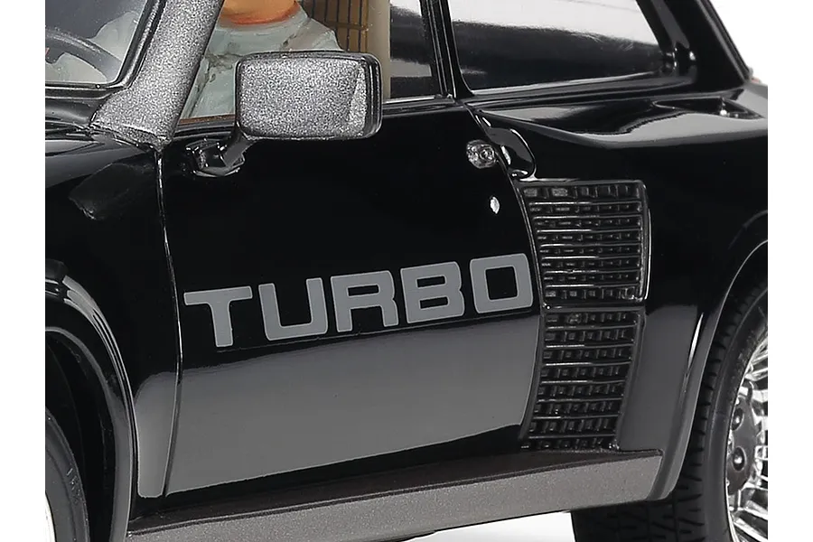 Close-up of a black Tamiya 1/24 scale Renault 5 Turbo model car showing the side door with TURBO decal and rear air intake.