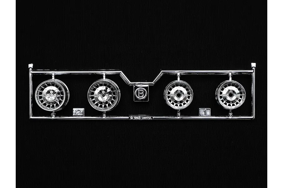 A chrome-plated plastic sprue containing four model car wheels for a Tamiya 1/24 scale Renault 5 Turbo kit.