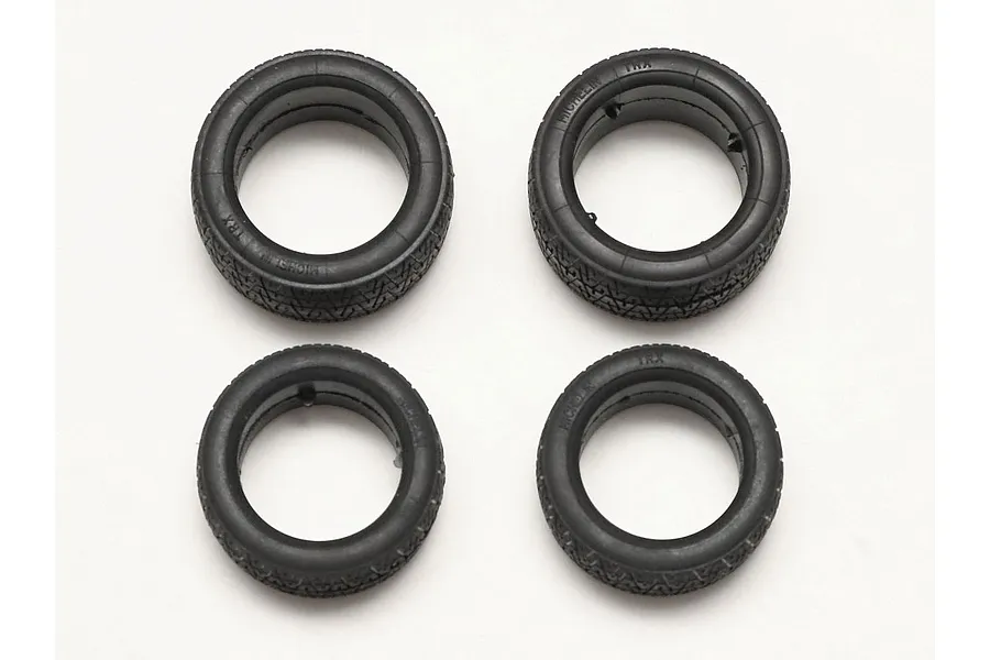 Four black rubber model car tires with Michelin TRX branding, arranged in a two-by-two grid on a white background.