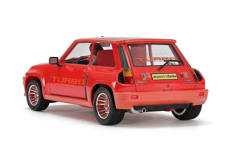 A rear three-quarter view of a red Tamiya 1/24 scale Renault 5 Turbo plastic model car on a white background.