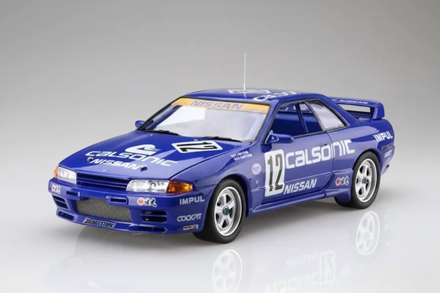 A studio shot of a 1/12 scale Calsonic Nissan Skyline GT-R model car in blue with racing decals.