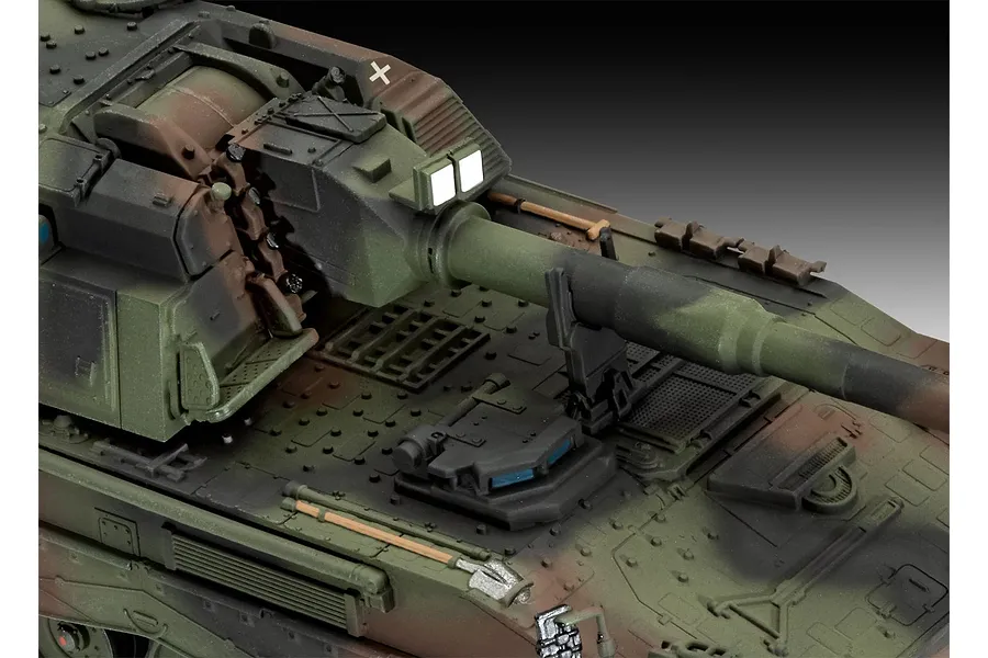 Close-up view of the turret and barrel of a painted 1/72 scale Panzerhaubitze 2000 model tank with camouflage paint.