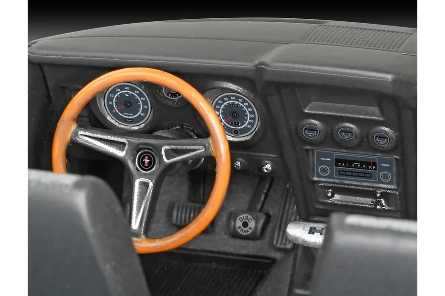 Close-up of the detailed interior of a 1/25 scale 1971 Ford Mustang Boss 351 model car, showing the dashboard, steering wheel, and gauges.