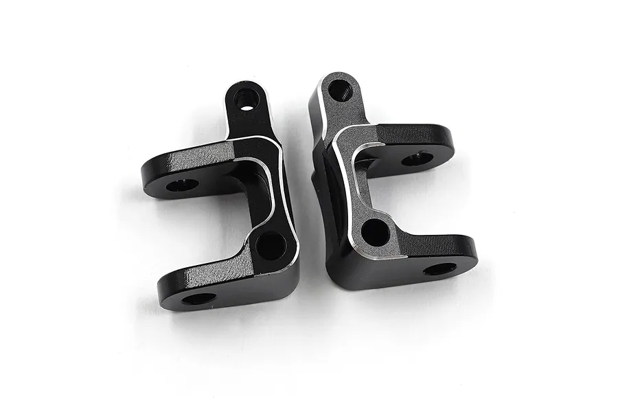 Two black anodized aluminium C-hub steering carriers for RC cars, featuring silver chamfered edges.
