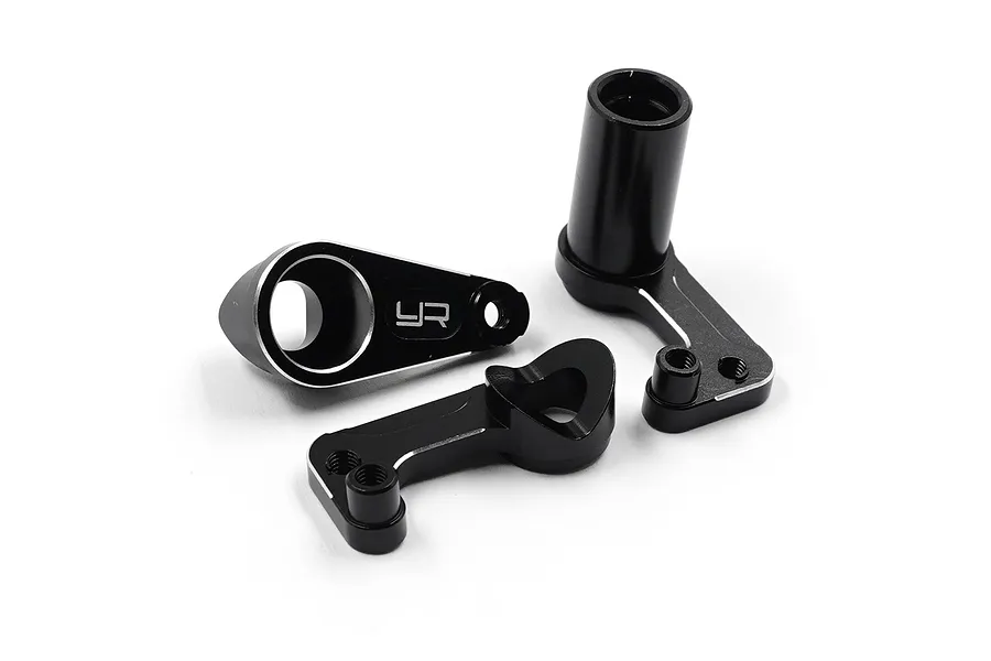 Three black anodized aluminium steering assembly parts for an RC car, featuring silver chamfered edges and the Yeah Racing logo.