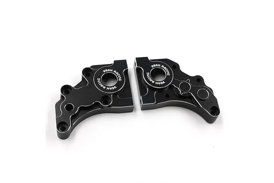 Two black anodized aluminium gearbox case halves for an RC car, featuring the Yeah Racing logo laser-etched around the central bearing holes.