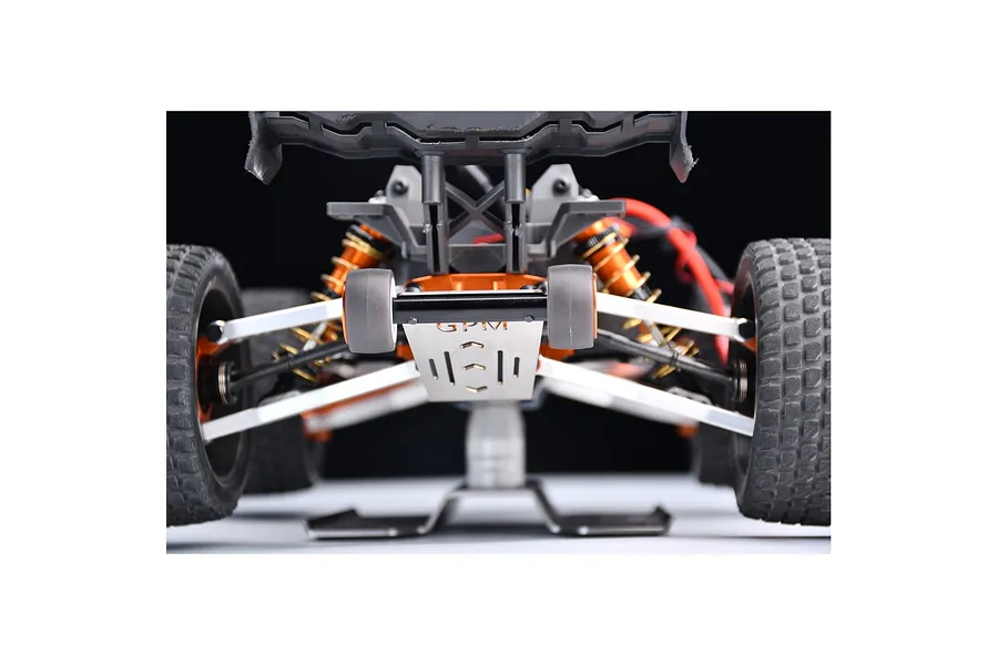 A close-up rear view of an RC car chassis featuring a GPM stainless steel wheelie bar installed.