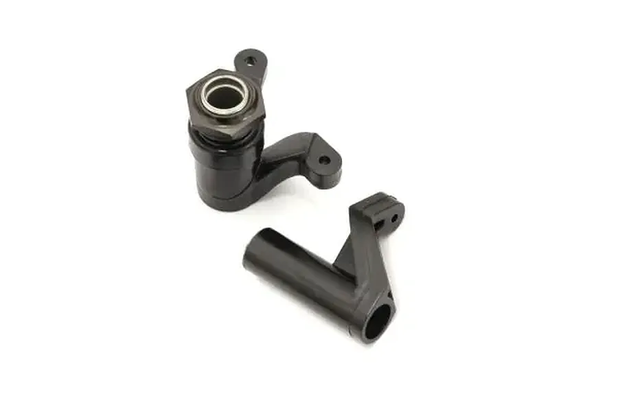 Kyosho servo saver assembly components, including a black plastic steering arm and a pre-assembled servo saver unit with a metal nut.