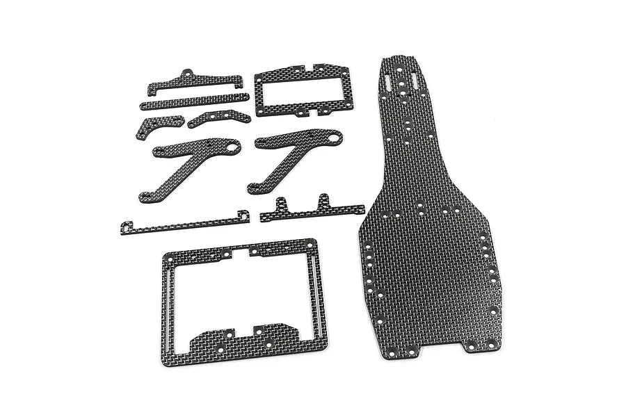 A set of carbon fibre RC car chassis conversion parts including a main deck and various braces laid out on a white background.
