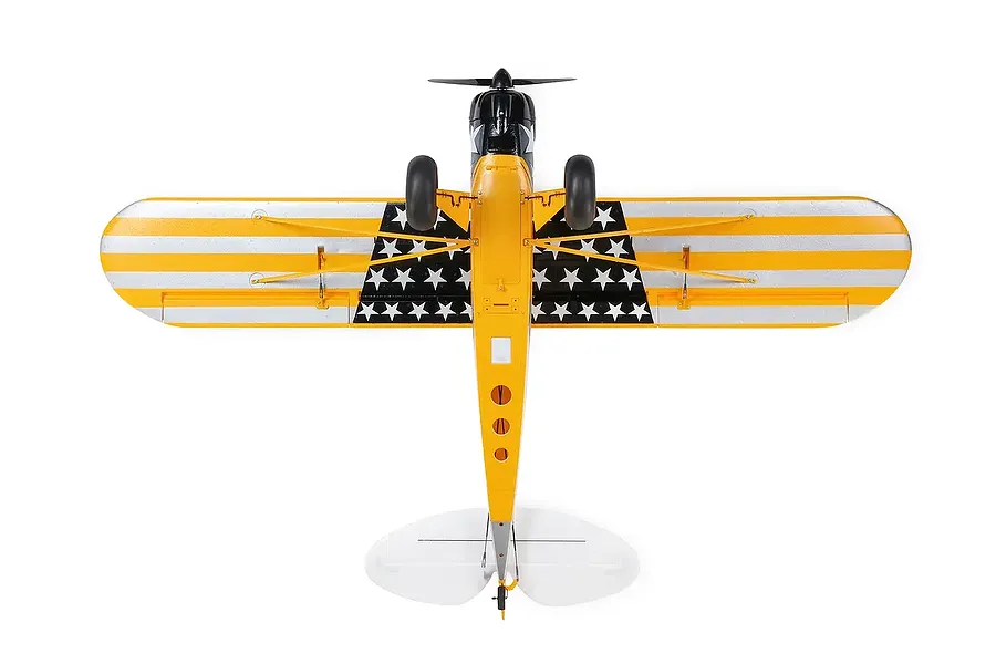 Bottom view of the HobbyZone Carbon Cub S 2 1.3m RC plane in Cleetus McFarland livery with yellow and silver striped wings and star patterns.