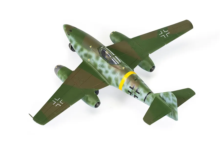 A high-angle studio shot of a fully assembled and painted 1/72 scale Messerschmitt Me 262 model aircraft with camouflage paint scheme.