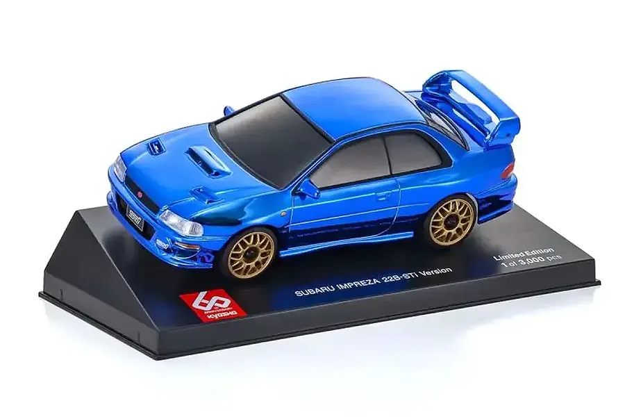 A chrome blue Kyosho Mini-Z Subaru Impreza 22B-STi 60th Anniversary body shell mounted on a black display stand against a white background.